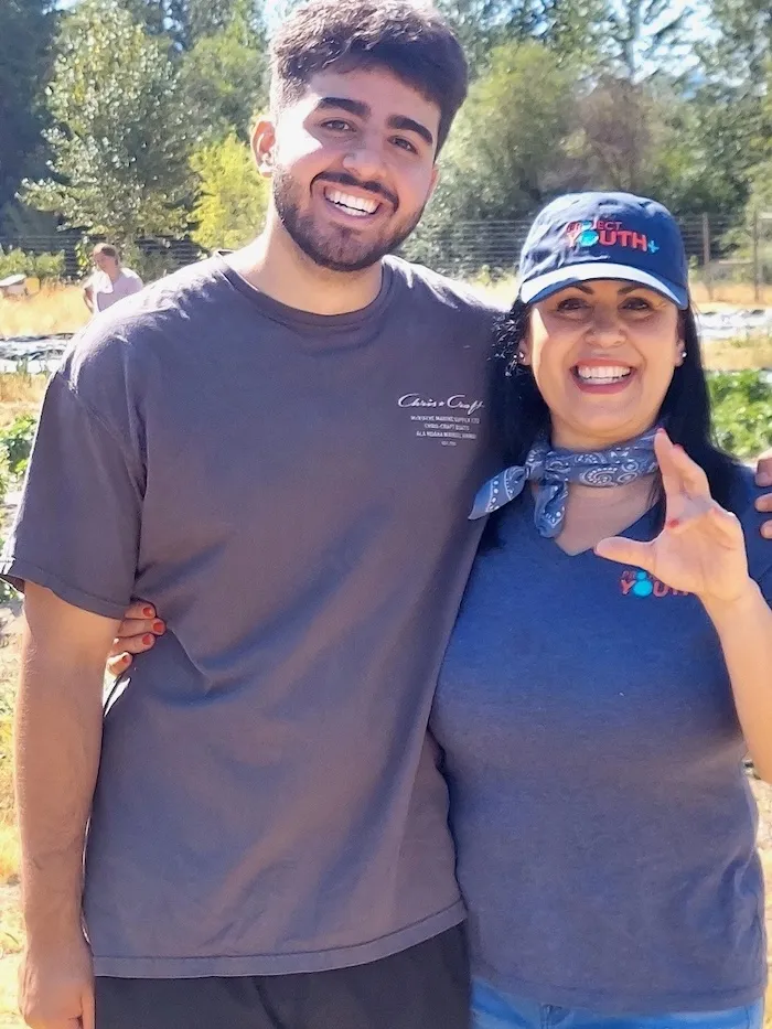 Lili Vargas, Community Resource Specialist, smiling outdoors with a colleague